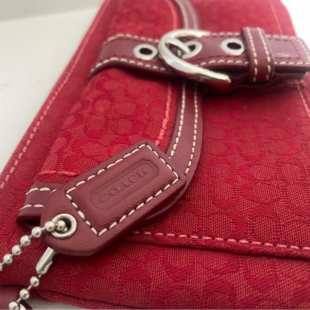 Coach canvas and leather red clutch with strap.